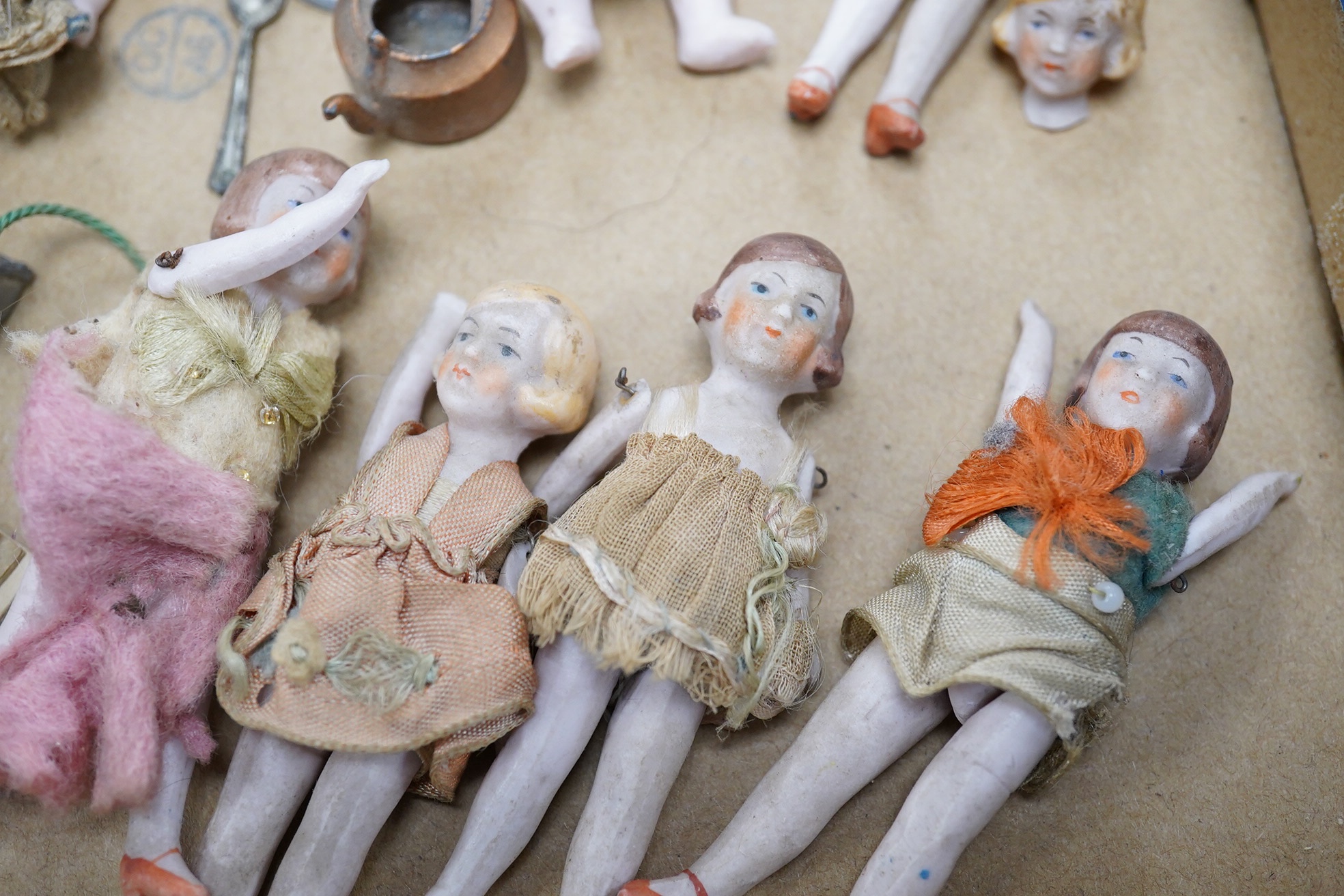 Eight early 20th century ceramic ‘doll's house’ dolls, approx 8cm long, with articulated limbs, together with a small quantity of doll house items by Pit-A-Pat series, etc. Condition - poor to fair.